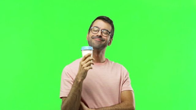 man holding hot coffee  on green screen chroma key background