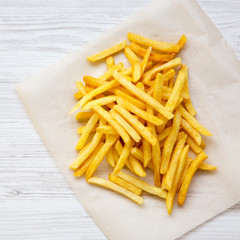 French fries over white wooden surface, overhead view. From above, top view, flat lay.