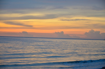 A golden scene of sunset reflection on the Haad Son beach, Khao Lak, Phang Nga, Thailand during summer time.