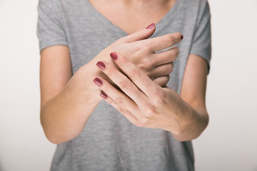 Parkinson's disease symptoms. Close up of tremor (shaking) hands of Middle-aged women patient with...
