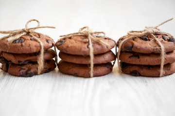 Homemade chocolate chip cookies on a white wooden background, side view. Close-up.