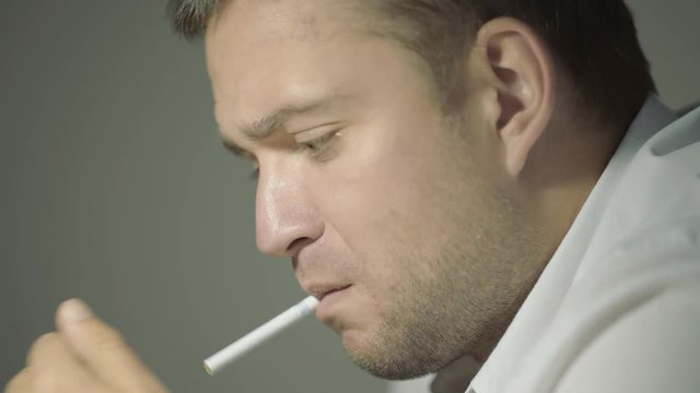 The guy detective in a white shirt listens to the interlocutor with a surprised face in his office