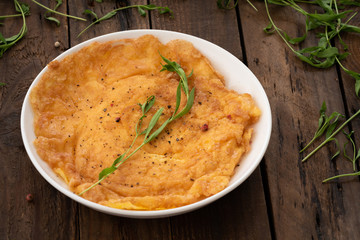 omelet on white plate with wood background