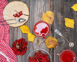tea from fresh berries of viburnum in a transparent glass cup, fresh red berries