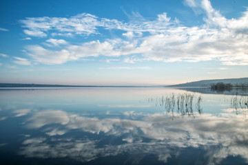 blue sky and clouds reflection in the lake stil water