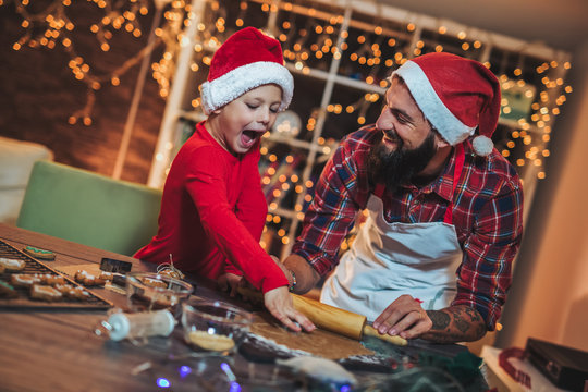 Father And Son Baking Gingerbread Christmas Cookies