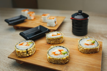 japanese seafood sushi and maki on wooden plate. Close up