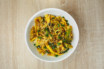 Warm salad with chicken, vegetable and sesame seeds. Close up