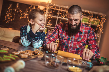 Father and son baking gingerbread Christmas cookies