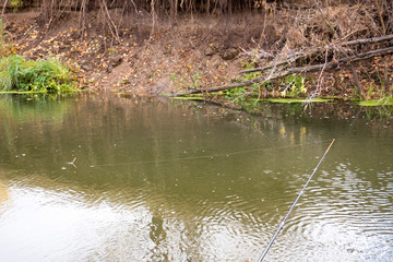 Fishing on the river, fishing rod, fishing line and float.