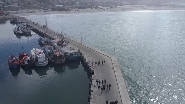 Aerial view of people walking on a harbour deck