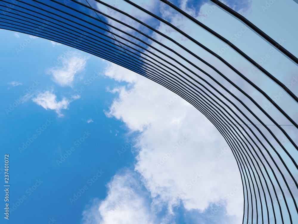 Leinwandbilder perspective of high rise building and dark steel window system with clouds reflected on the glass.bu