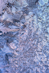 Winter background. Frost and ice crystals on window glass.