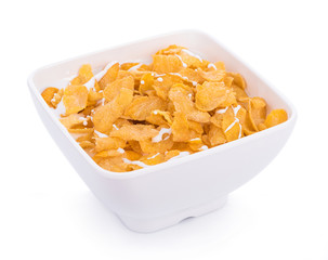 Corn flakes with milk in bowl isolated on white