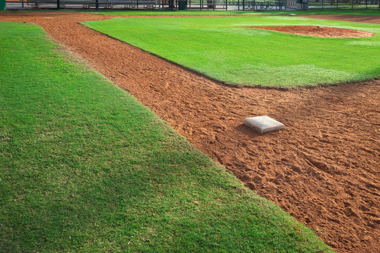 Youth baseball infield from first base side in morning light