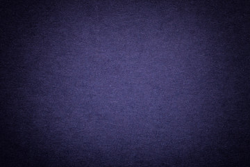 Texture of old navy blue paper background, closeup. Structure of dense cardboard.