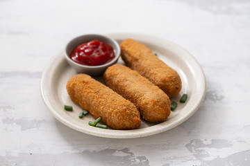 meat croquets with sauce on dish