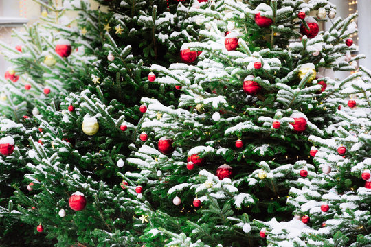 Decorated Christmas tree with balls, garland on fair. Outdoor. Xmas card and pattern. Winter.