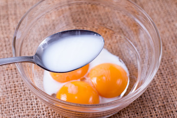 Adding milk to egg yolks