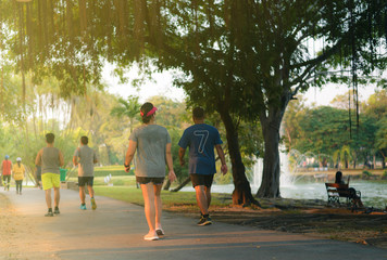 Group of people running in the park on a evening sunset,healthy and relax concept.