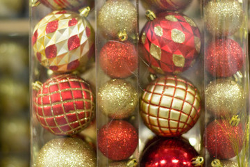 Red and gold christmas tree balls in plastic tubes. New year and christmas background.
