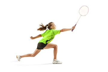 The one caucasian young teenager girl playing badminton at studio. The female teen player isolated on white background in motion