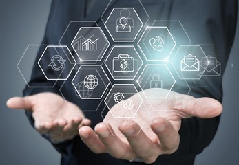Man touching business elements icons on screen