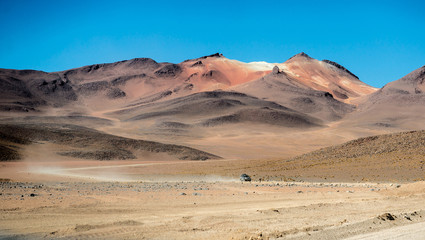 Fototapeta na wymiar Car riding in Bolivian sunshine landscape