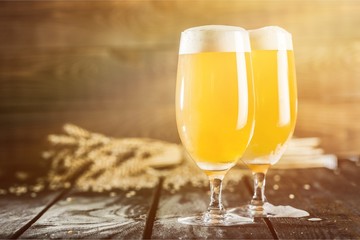 Mugs of cold beer with foam, close-up view