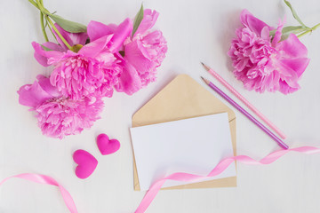 Mockup white greeting card and envelope with pink peonies