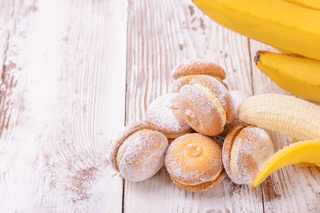 Homemade banana sandwich cookies on a light wooden background