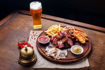 Big set of snacks for beer or alcohol and it includes smoked pork meat, french fries, fried bread, crab sticks and nuts