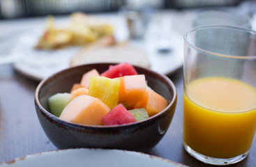 Health and Fitness Cooking. Fruit in Bowl. Breakfast on a Plate with Eggs, Orange Juice, Bread. Delicious Meal on Table. Healthy Diet Nutrition. Vitamins and Minerals. 