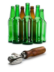 Old can opener against group of empty beer bottles