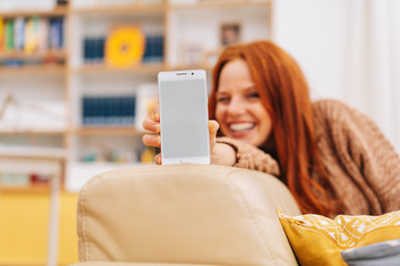 Happy smiling woman holding a mobile phone