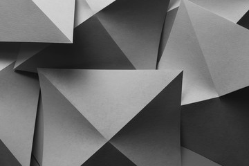 Composition with gray paper folded in geometric shapes