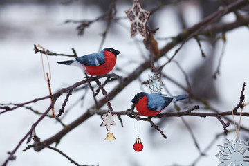 wooden bullfinches on the tree branch/new year and christmas background