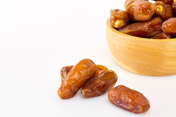 Bowl of dried dates on white