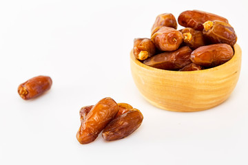Bowl of dried dates on white