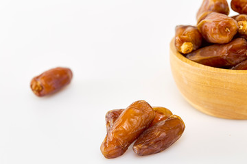 Bowl of dried dates on white