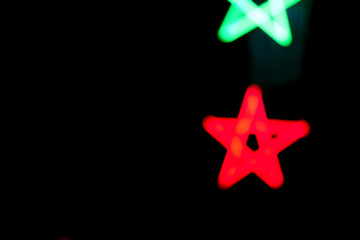 Fluorescent light star shape on black night.