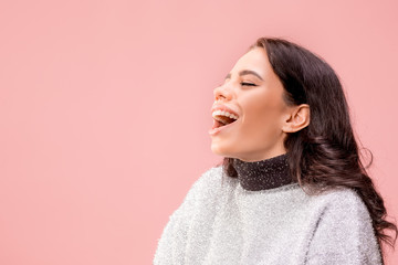 Happy business woman standing and smiling isolated on pink studio background. Beautiful female half-length portrait. Young emotional woman. The human emotions, facial expression concept