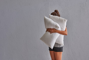 Girl pillow and sleep concept, grey stone wall decor.