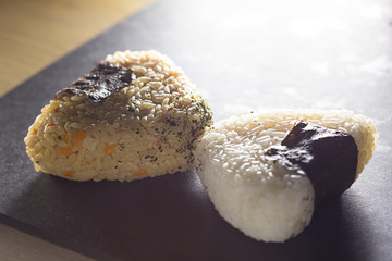 Two triangle sushi of yellow and white rise