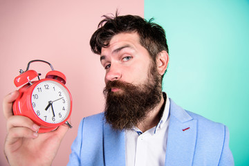 Time management skills. Time to work. Man bearded sleepy tired businessman hold clock. Stress...