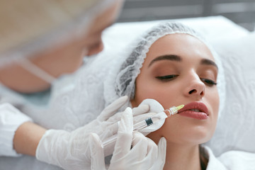 Lip Augmentation. Woman Getting Beauty Injection For Lips