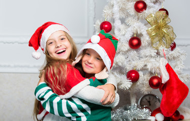 Winter masquerade concept. Siblings ready celebrate christmas or meet new year. Merry christmas. Family holiday tradition. Children cheerful celebrate christmas. Kids christmas costumes santa and elf