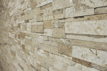 uneven light brown cream stone marble wall  taken from side way selective focus