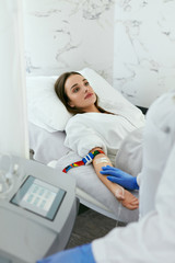 Blood Ozone Therapy. Woman At Blood Transfusion Treatment 