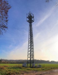 Electric antenna and communication transmitter tower in a german landscape